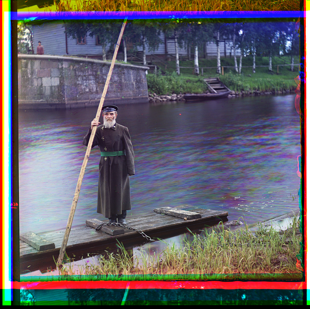 a trichromy by Prokudin-Gorsky showing a man with a long pole on a raft or pontoon.